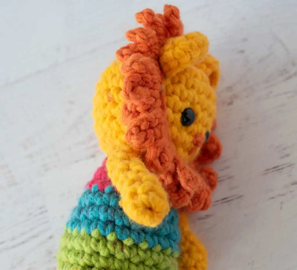 Side view of main on crochet lion.